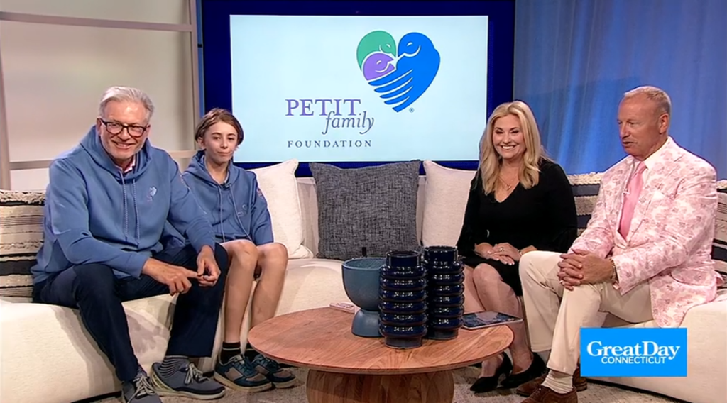 Four people on a TV set discussing the Petit Family Foundation 5K Road Race.